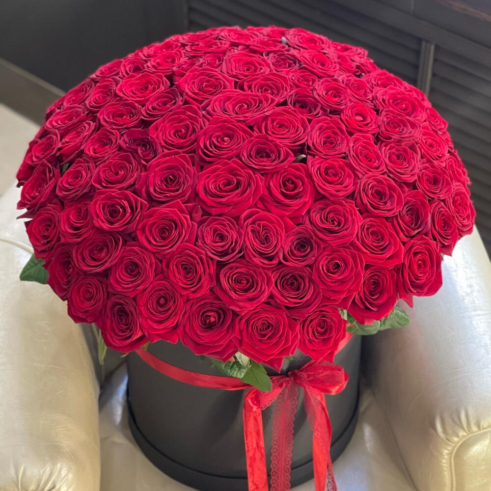 Large bouquet of red roses in a black  hat box with a red ribbon